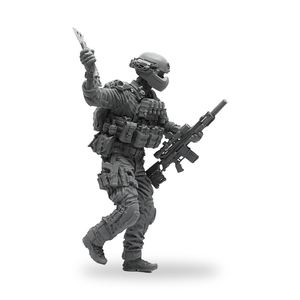 Unpainted US Navy SEAL soldier figure holding knife and rifle in dynamic pose.