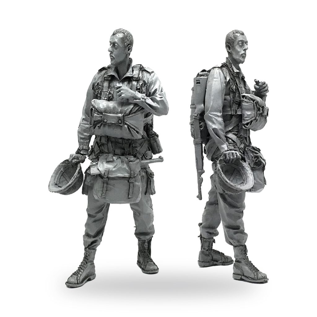 Unpainted WWII US soldier figure in combat gear with helmet and backpack.