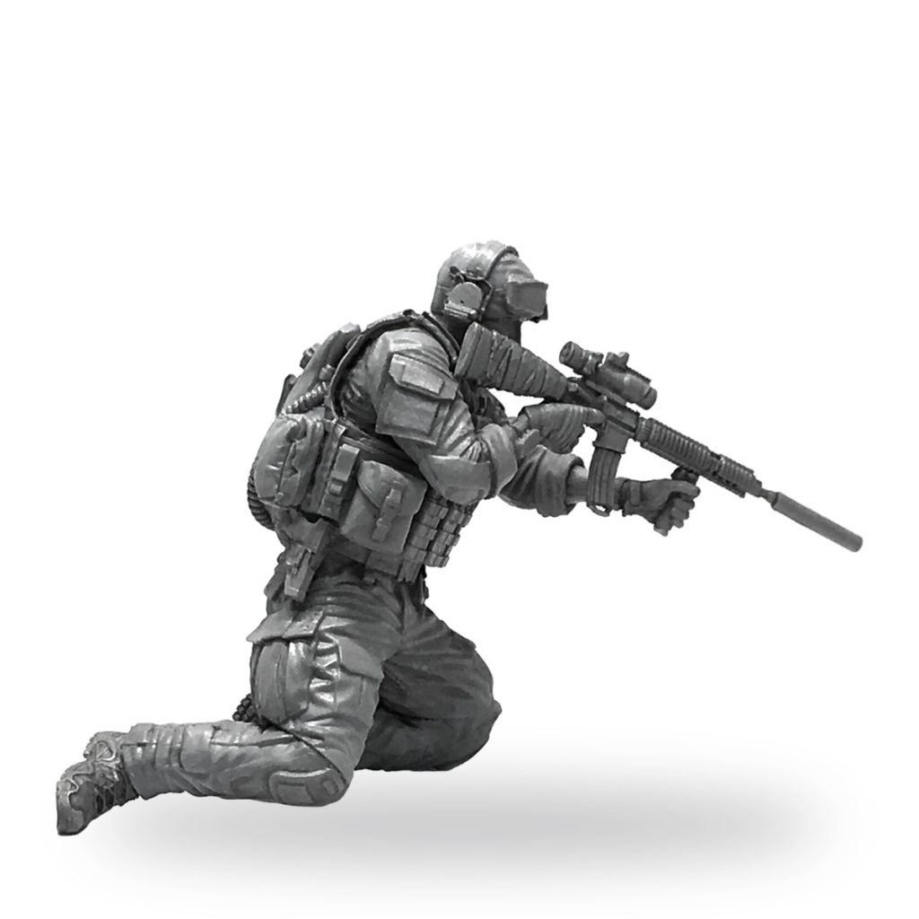 Unpainted US Army Special Forces soldier in tactical gear aiming rifle.