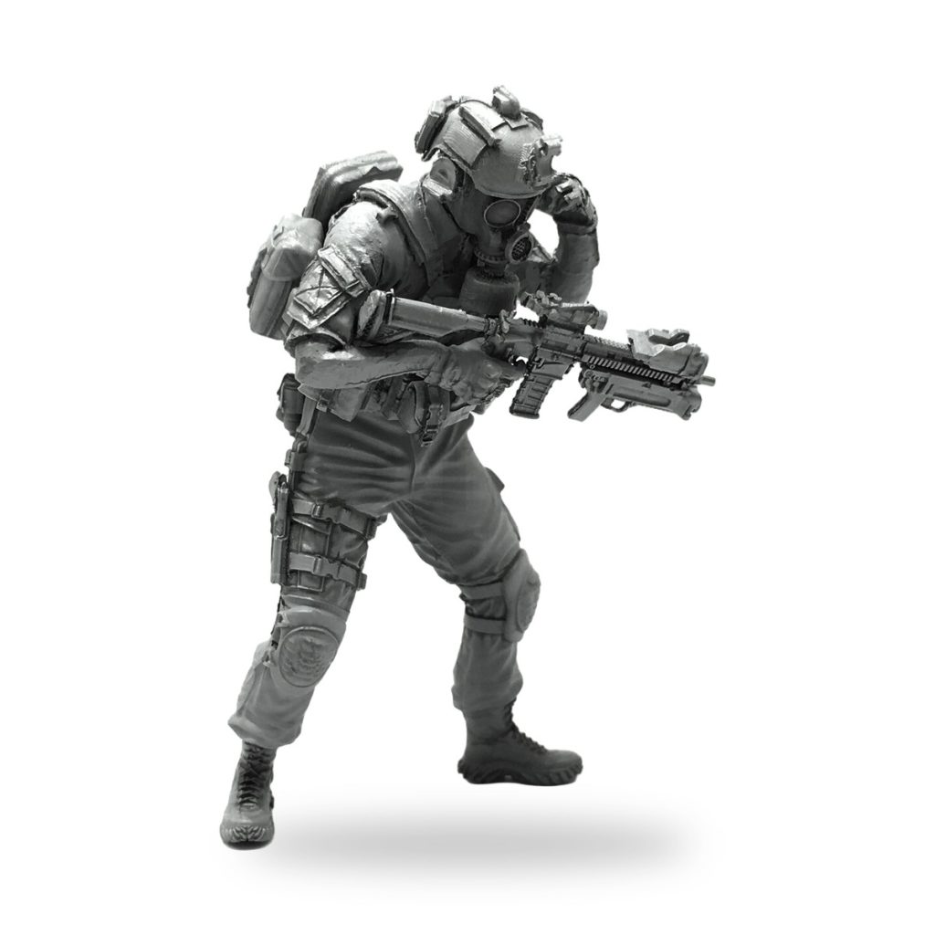 Unpainted 1/35 US Navy SEAL Delta soldier figure in tactical gear holding rifle.