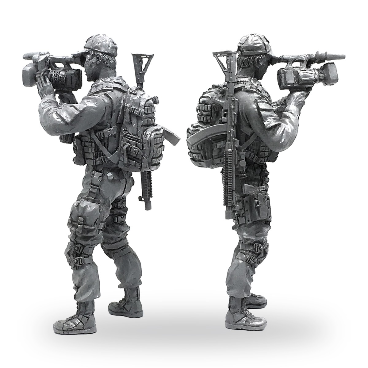 Unpainted 1/35 scale soldier figure holding video camera with backpack and rifle.