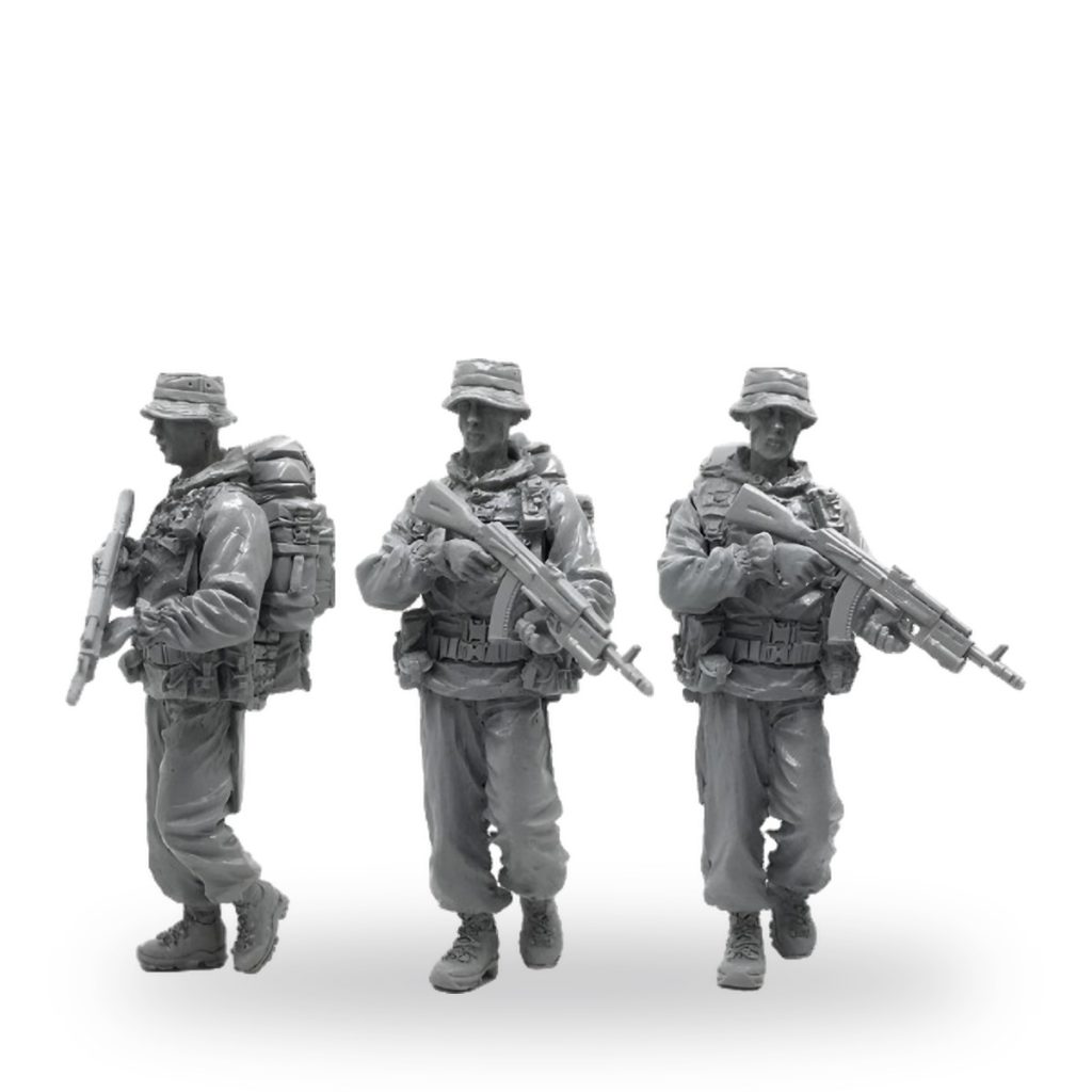 Three unpainted US Army Special Forces soldier figures in gear with rifles.
