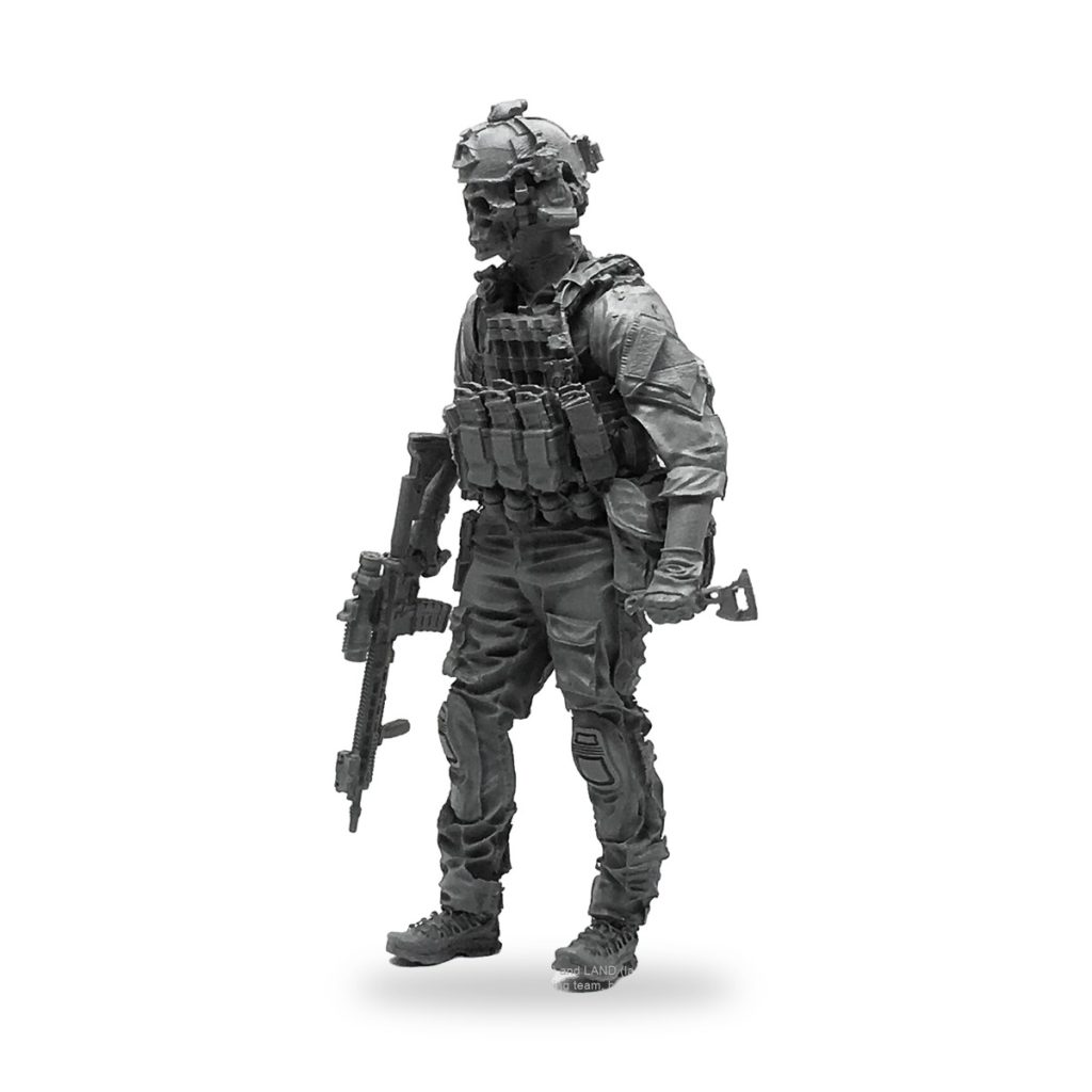 Unpainted 1/35 scale modern soldier in full battle gear with skull helmet and rifle.