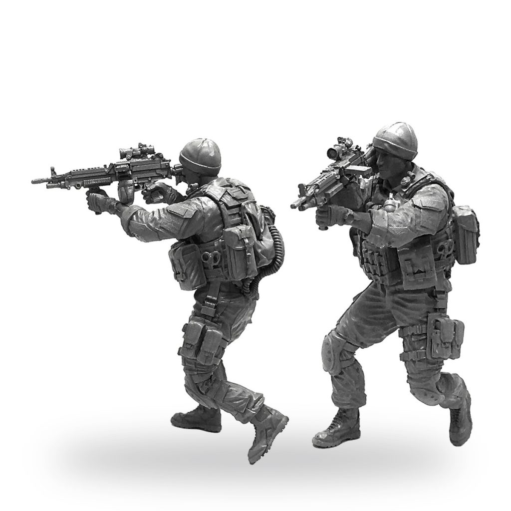 Unpainted US Marine Corps soldier figures in combat gear with rifles.