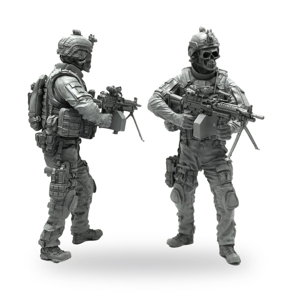 Unpainted 1/35 scale soldier figure with skull mask and assault rifle.