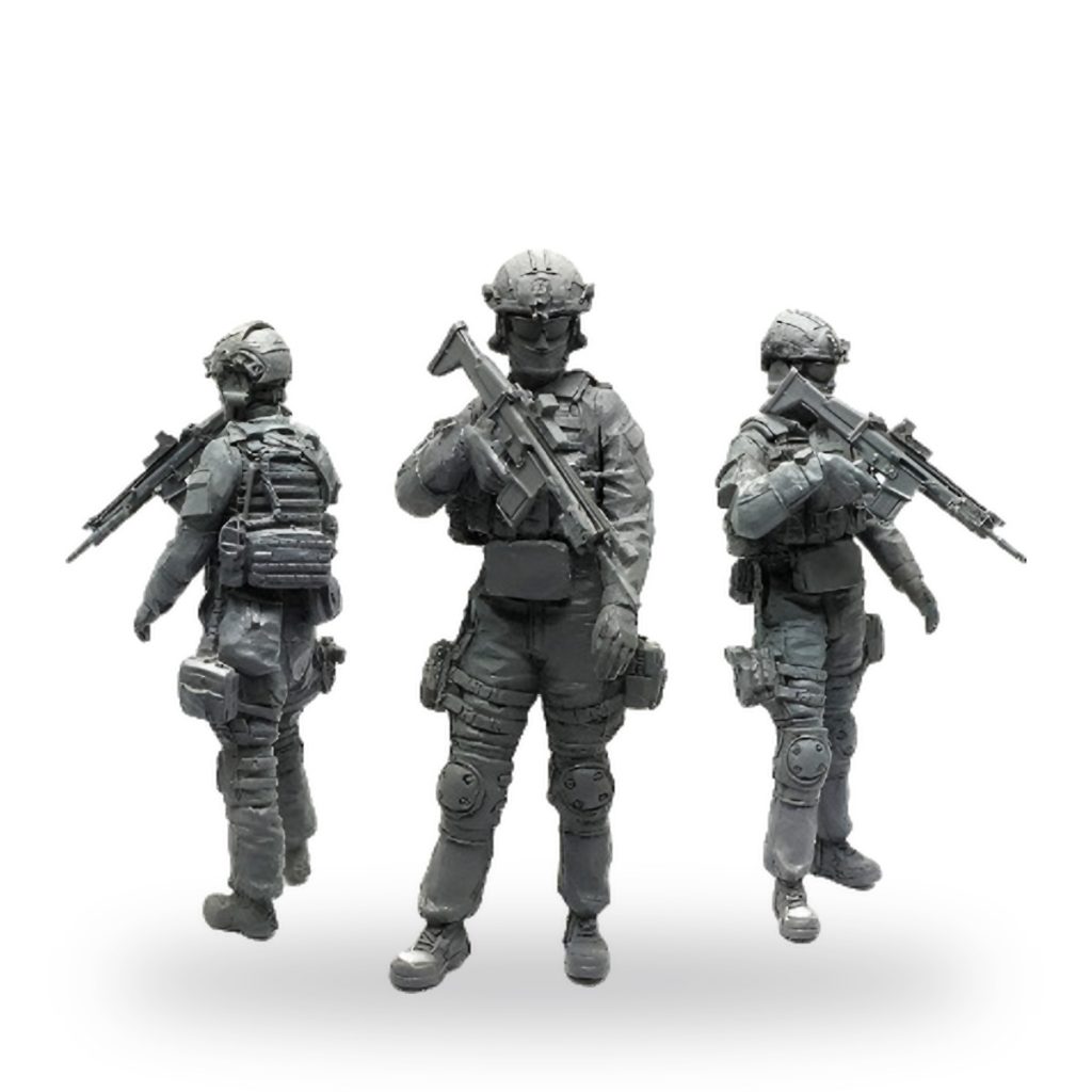 Unpainted US Special Forces soldier figure in tactical gear holding rifle.