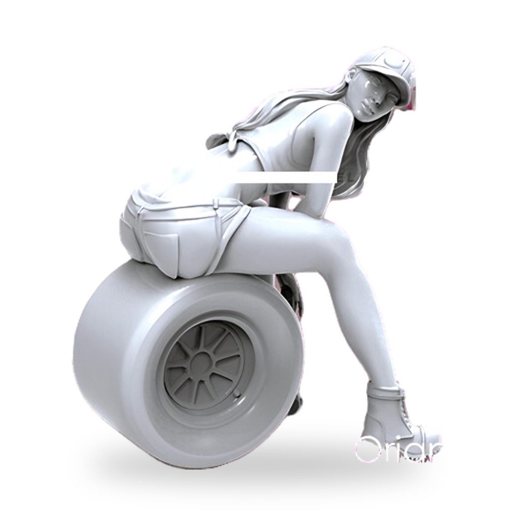 Unpainted resin figure of girl mechanic sitting on race car wheel.