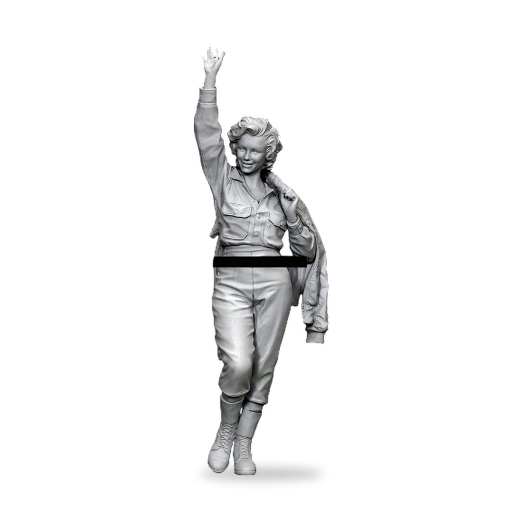 Unpainted Marilyn Monroe-style figure in flight suit waving.