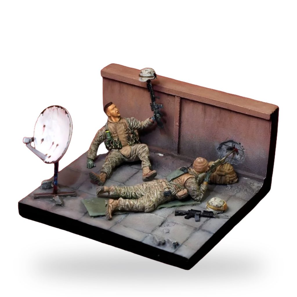 Unpainted US soldier miniature diorama showing two soldiers in combat position near satellite dish and wall with bullet hole.