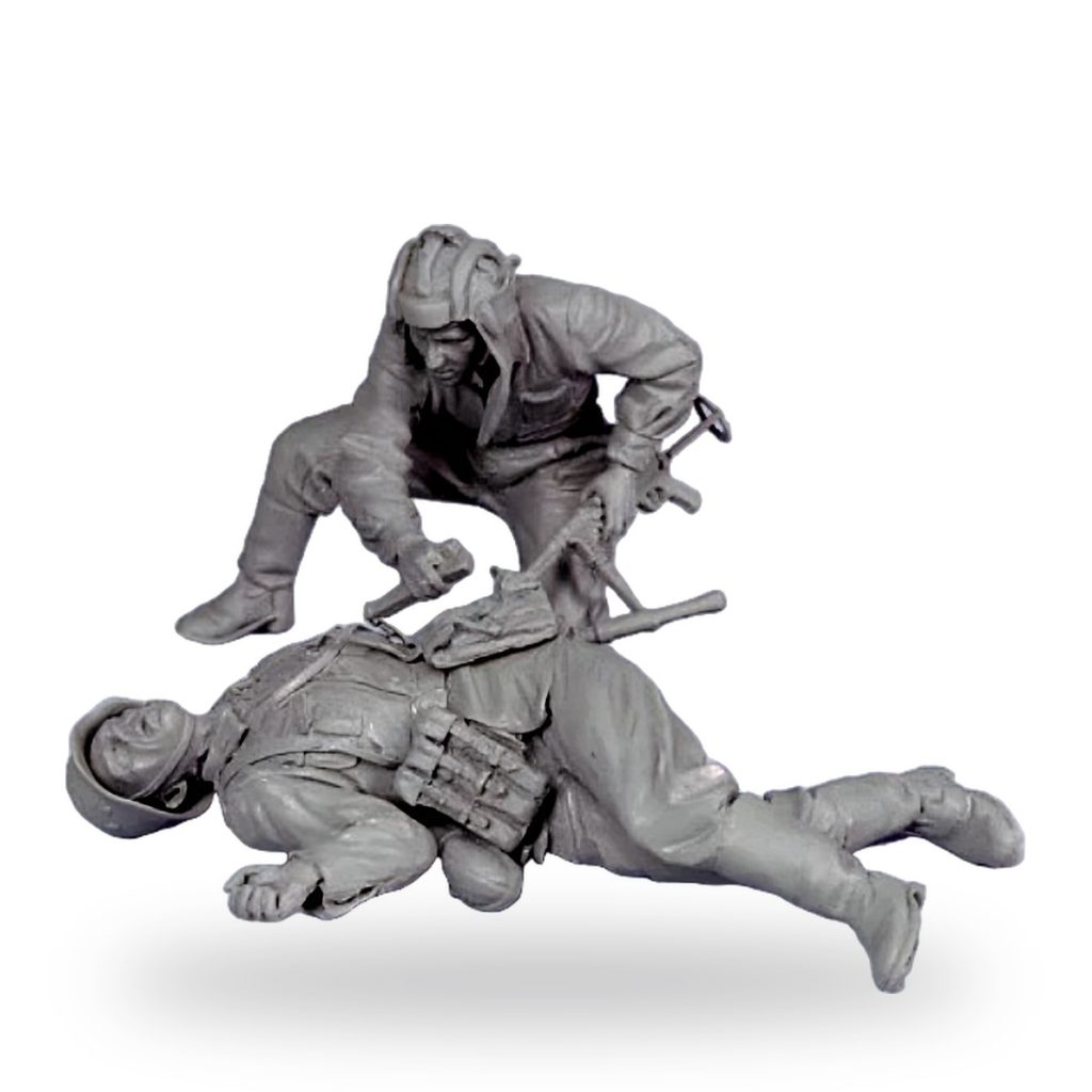 Unpainted Soviet soldier miniature showing one kneeling over another fallen figure in winter gear.