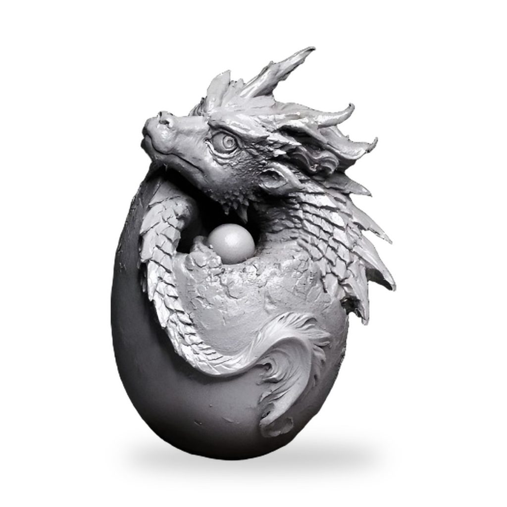 Unpainted Chinese dragon coiled around egg with pearl inside.