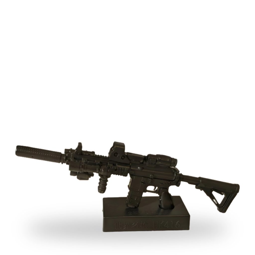 Unpainted black HK416 assault rifle plastic model on display stand.