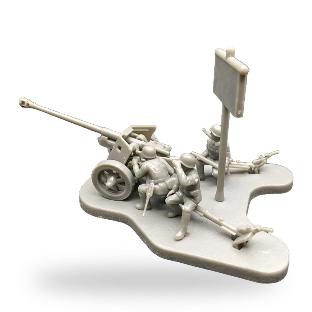 Unpainted WWII anti-tank artillery crew with gun and sign on base.