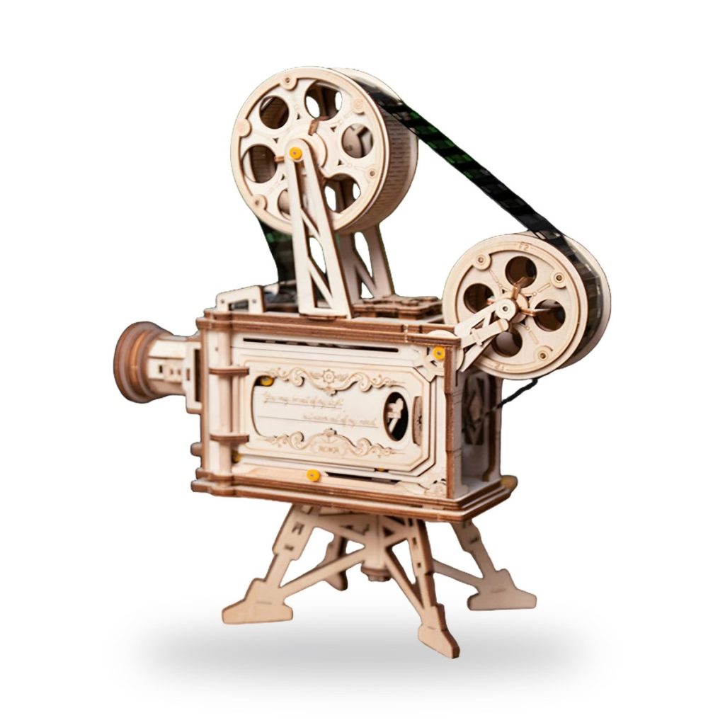 Unpainted wooden film projector with reels and hand crank mechanism.