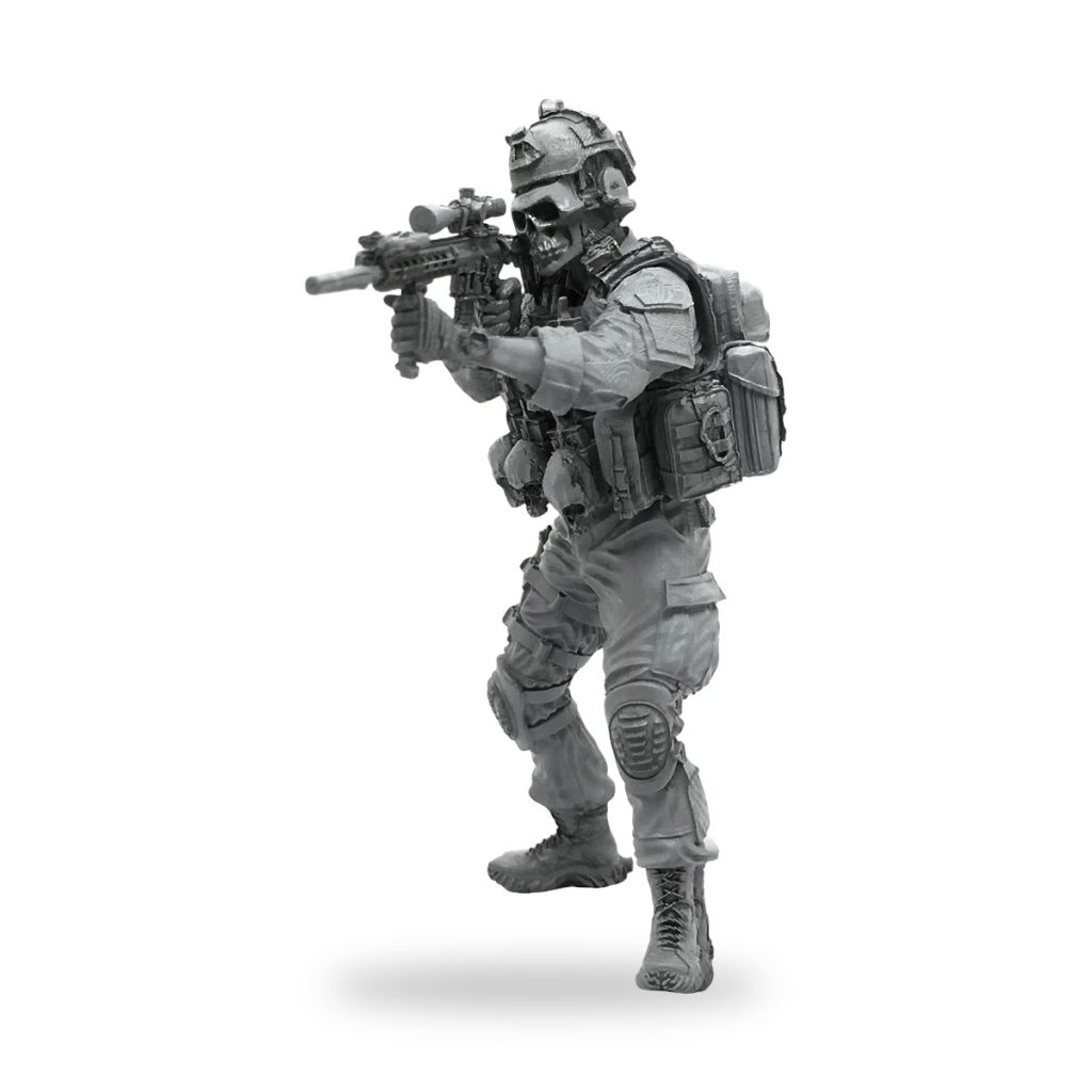 Unpainted US Special Forces soldier miniature in tactical gear holding rifle.