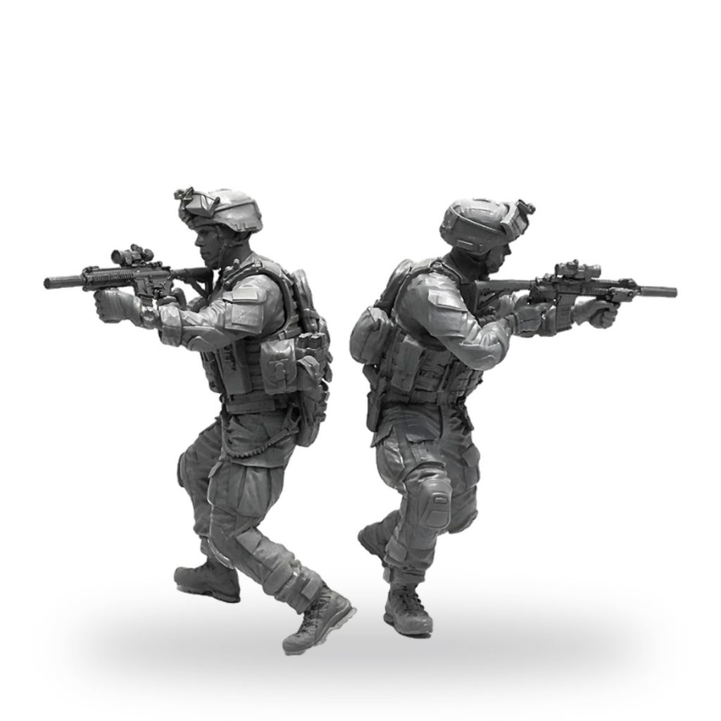 Unpainted US Navy SEAL miniature in tactical gear with rifles.