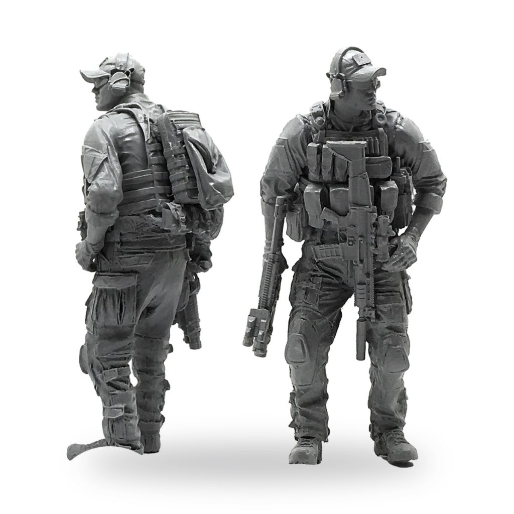 Unpainted 1/35 scale modern soldier miniature in tactical gear with rifle and backpack.
