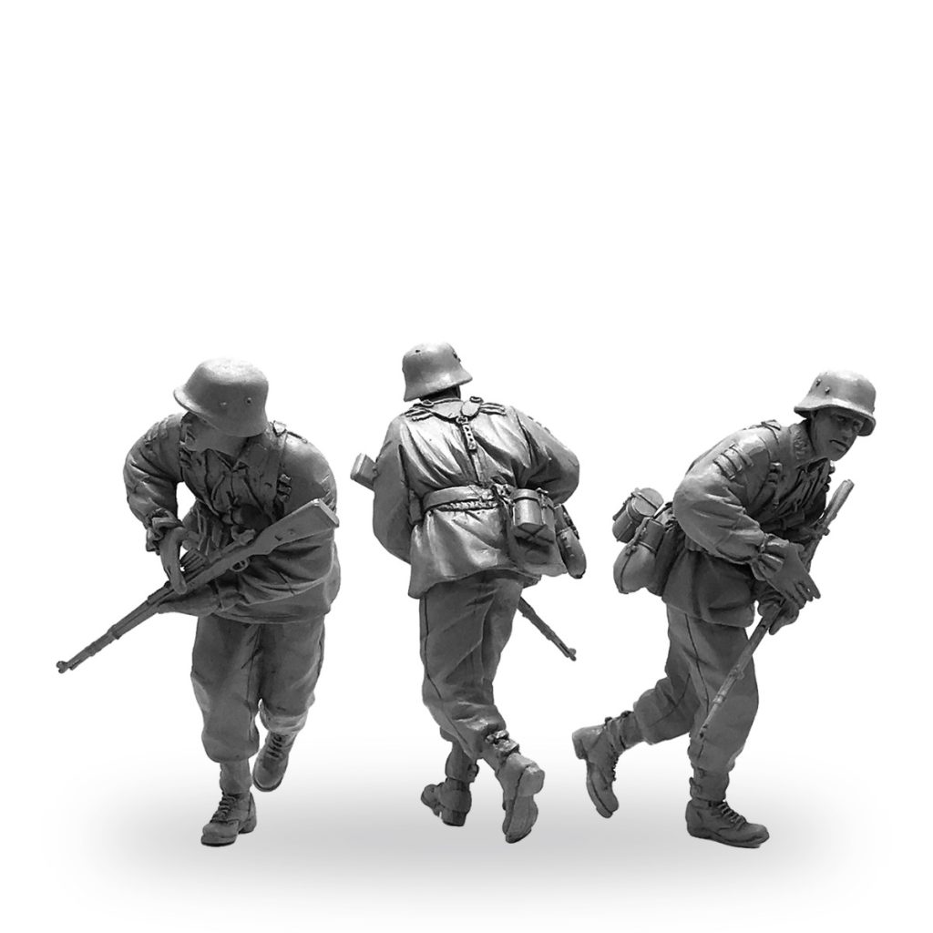 Three unpainted WWII German soldier miniatures in running poses with rifles and gear.