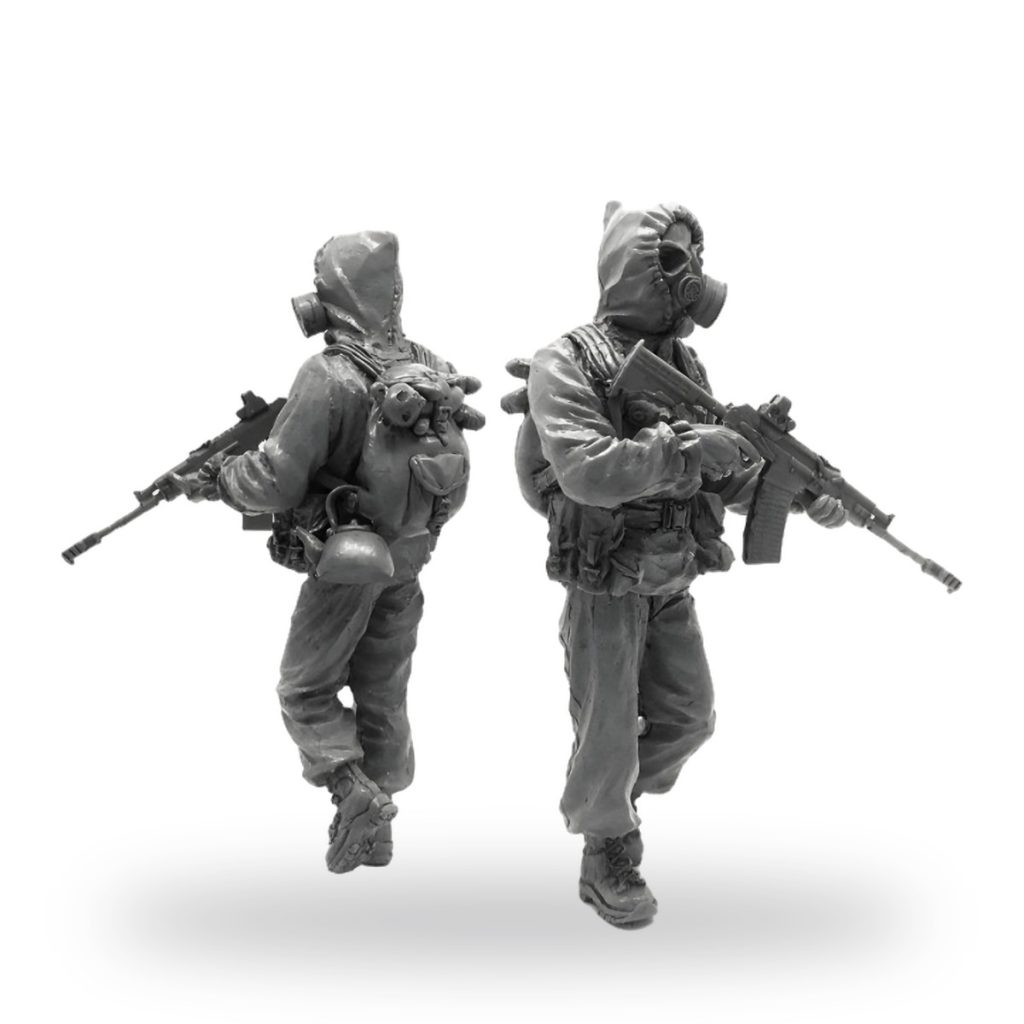 Unpainted 1/35 scale resin figures of two soldiers in hazmat gear with rifles.
