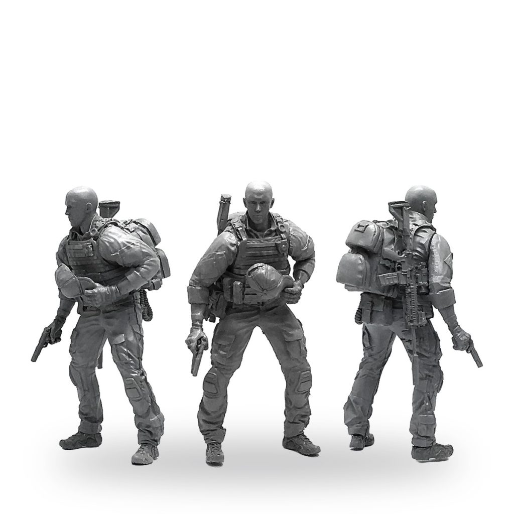 Unpainted 1/35 scale soldier miniature in tactical gear with weapons and backpack.