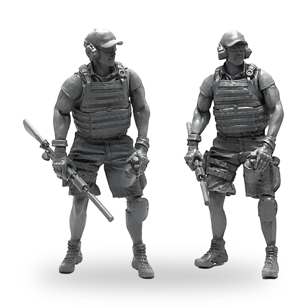 Unpainted resin miniature of two armed soldiers in tactical gear.