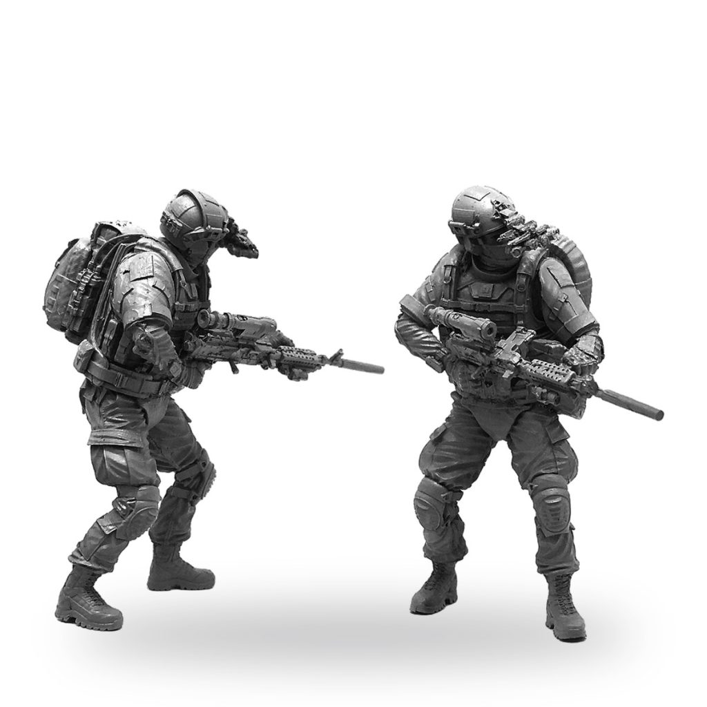 Unpainted modern elite soldier miniature in tactical gear with rifle.