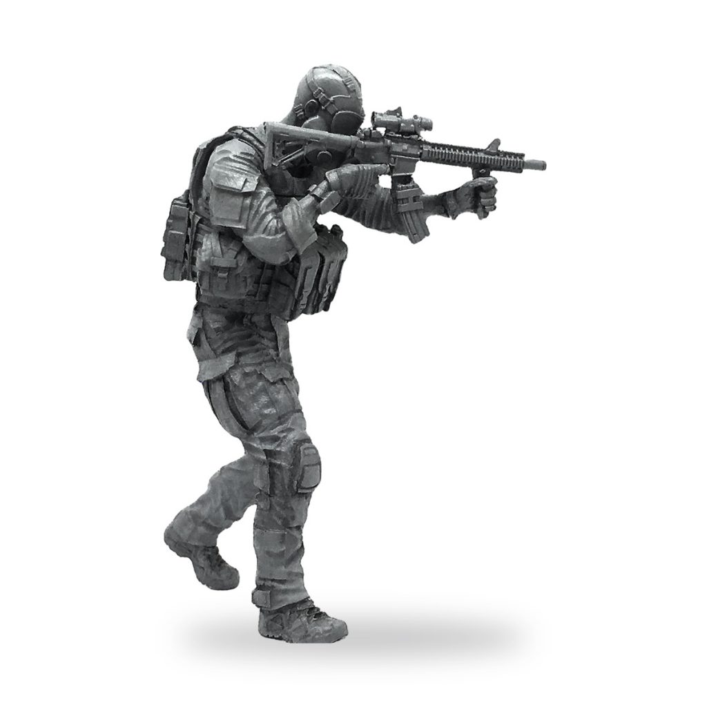 Unpainted 1/35 scale modern soldier miniature in tactical gear holding rifle.