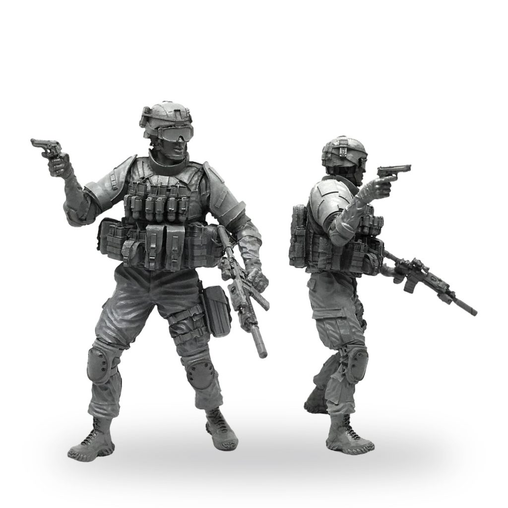 Unpainted 1/35 scale marine soldier miniature in combat gear with weapons.