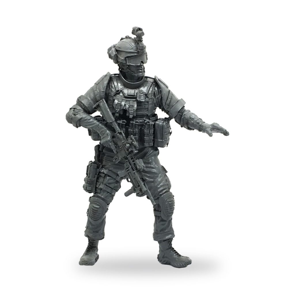 Unpainted 1/35 SEAL soldier miniature in full battle gear holding rifle.