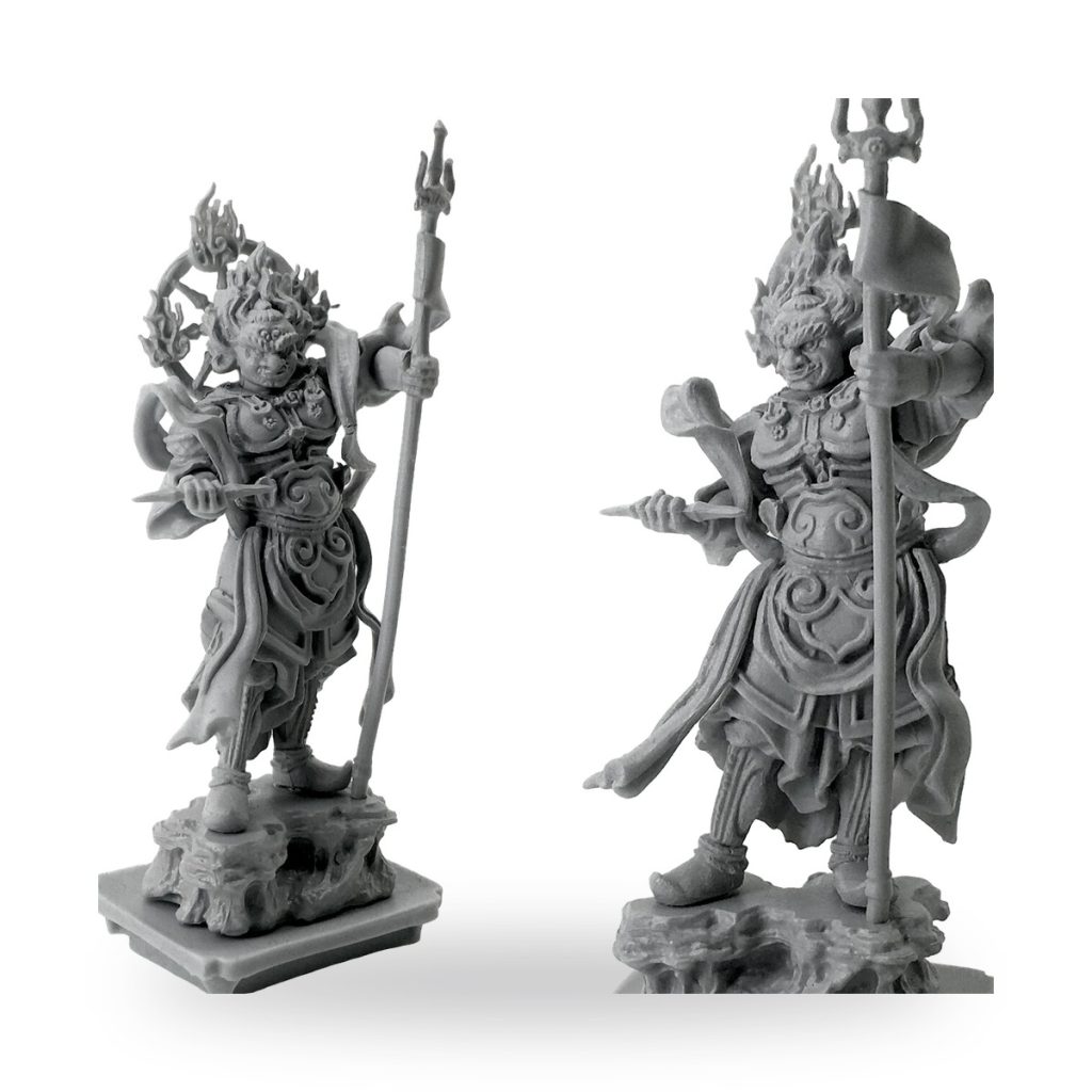 Unpainted resin figures of ancient Japanese temple guardians holding weapons and standing on rocky bases.