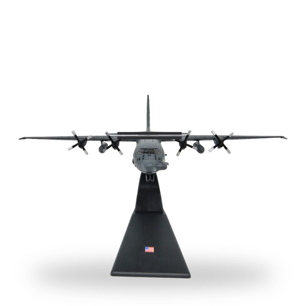 Unpainted Lockheed AC-130 Gunship miniature model on black stand with US flag.