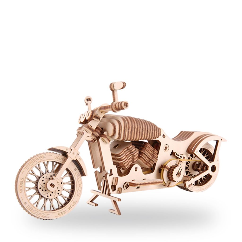Unpainted wooden motorcycle model with detailed mechanical parts and wheels.