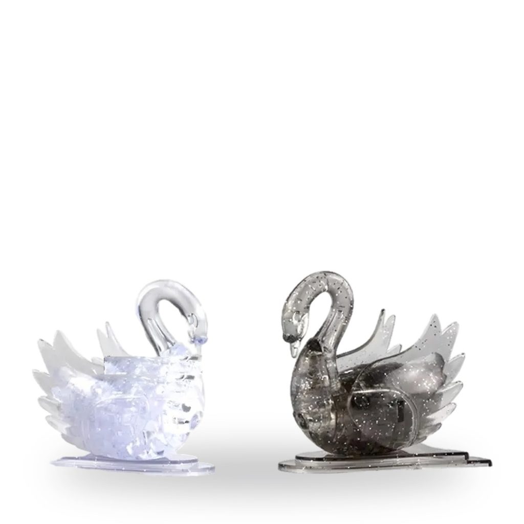 Two glittering swan models made from assembled crystal-like plastic blocks.