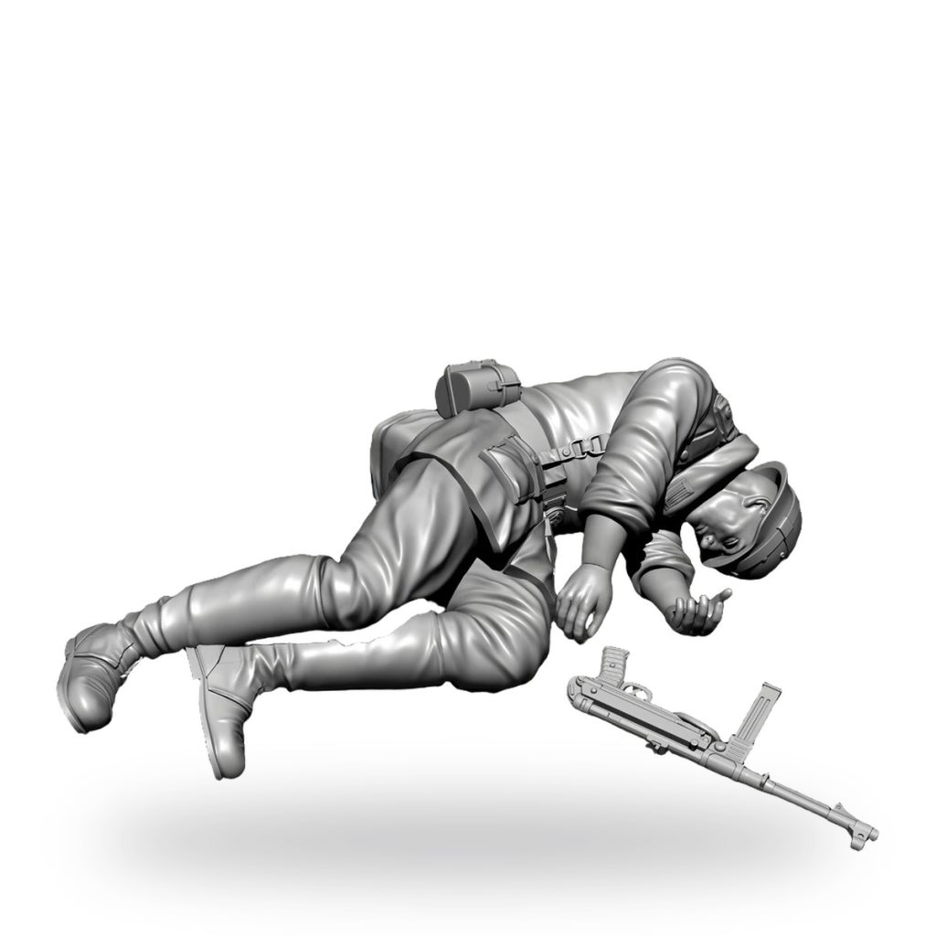 Unpainted WW2 soldier figure lying prone with helmet and rifle beside him.