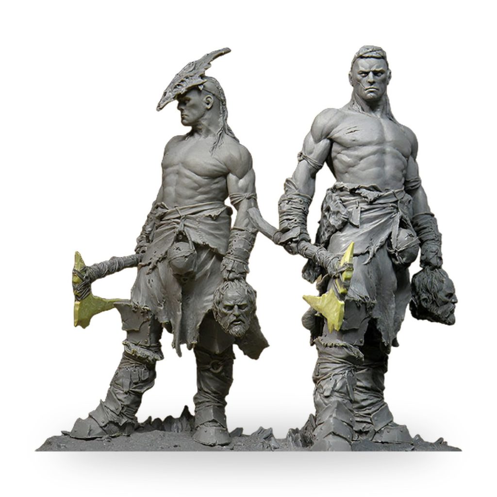 Unpainted resin figures of two muscular barbarians holding axes and severed heads.