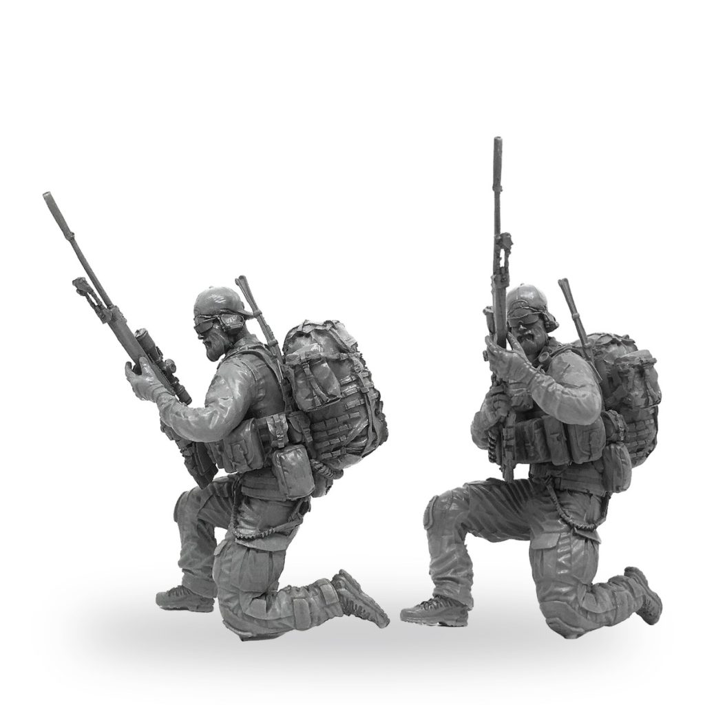 Unpainted US Navy SEAL sniper and rifleman in combat gear kneeling with rifles.