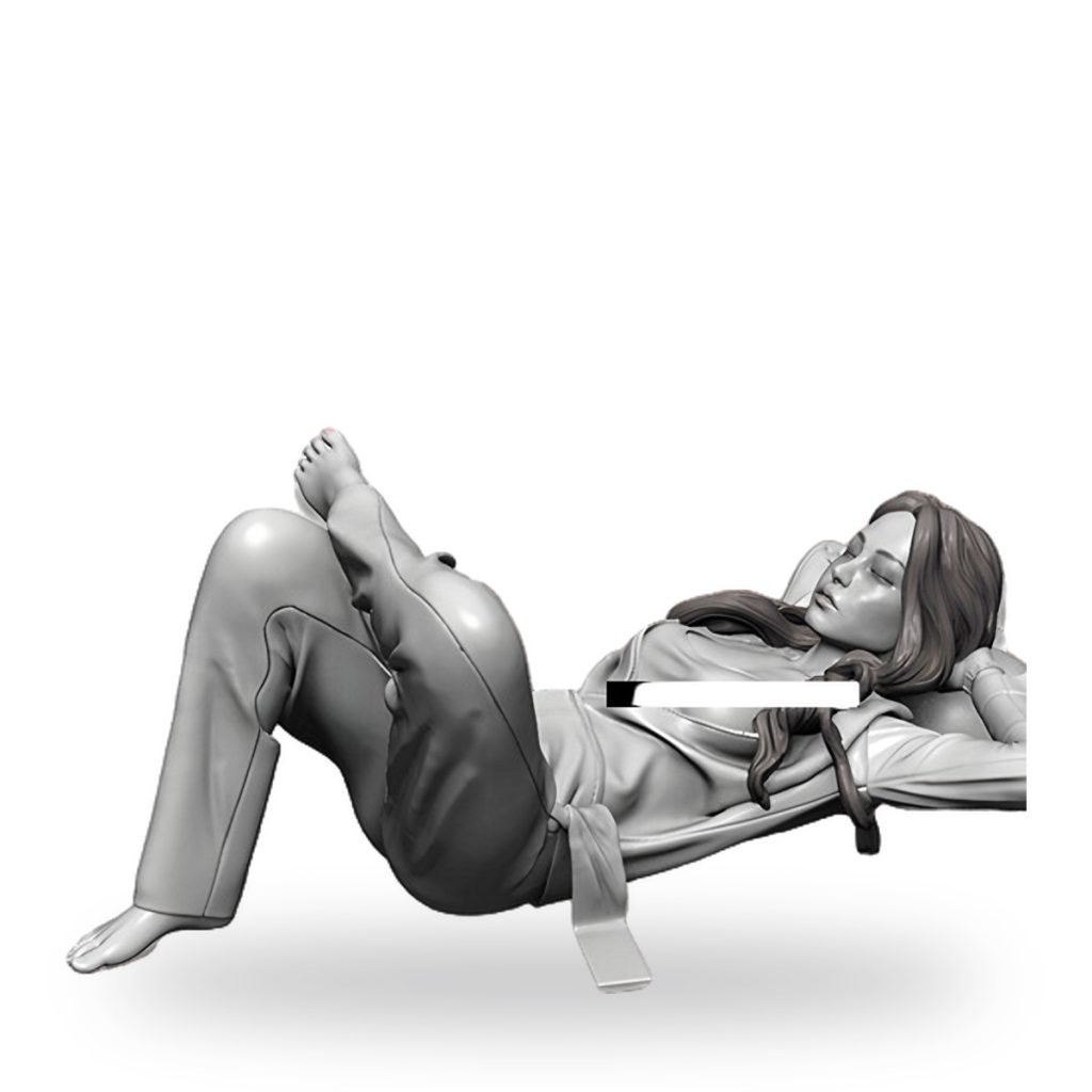 Unpainted resin figure of girl sleeping on couch in mechanic outfit.