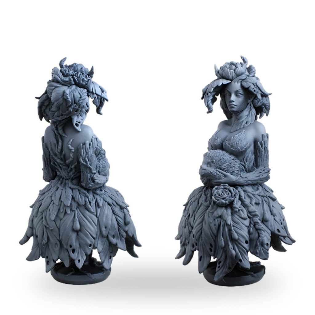 Unpainted fairy bust with leaf dress holding hedgehog.