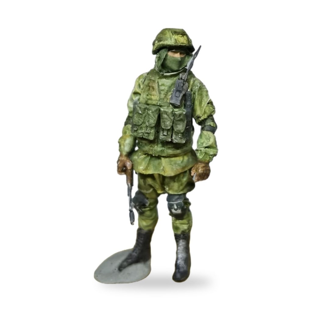 Unpainted 1/35 resin miniature of modern Russian soldier in green camouflage gear with rifle and shovel.