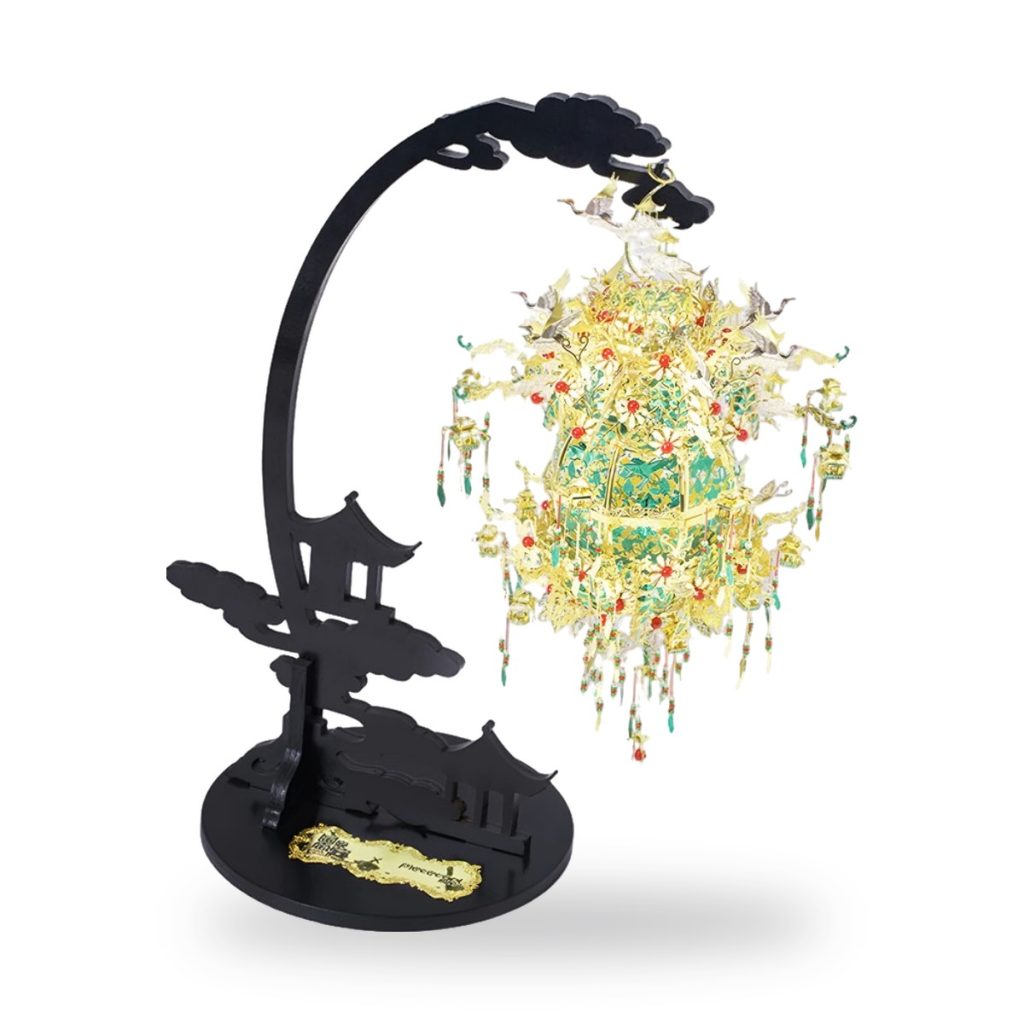 3D puzzle of ornate Chinese lantern with cranes and pagoda silhouette on black stand.