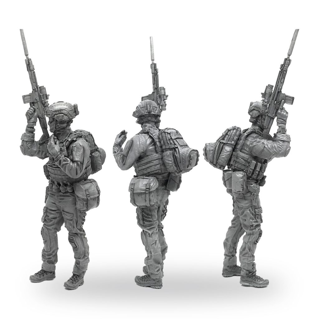 Unpainted US Navy SEAL soldier miniature in three poses with rifle and gear.