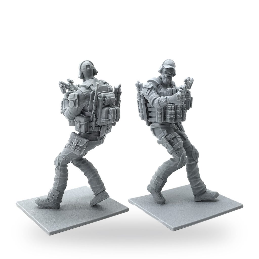 Unpainted resin miniature soldier in tactical gear with backpack and rifle.