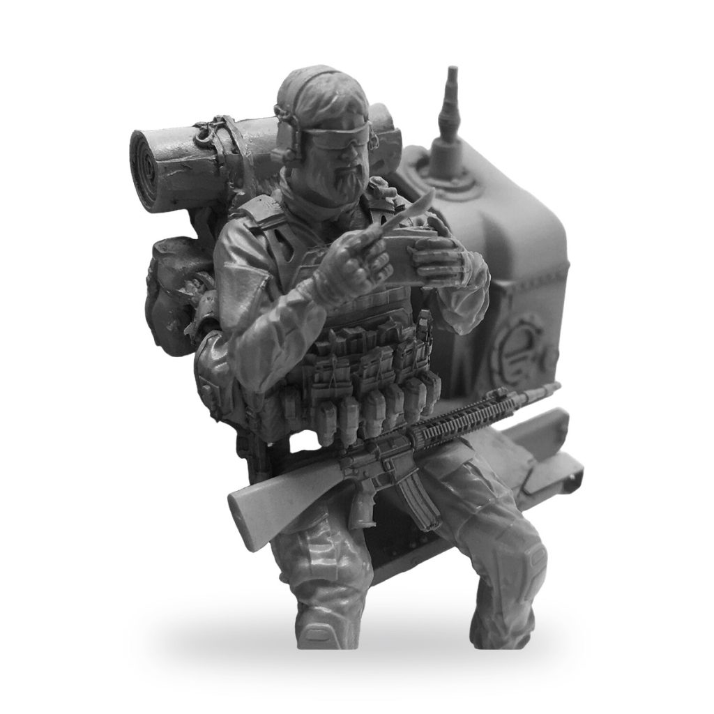 Unpainted US Navy SEAL soldier figure sitting and eating with gear.